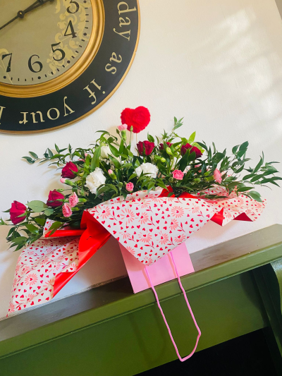 True Romance - A romantic red rose arrangement featuring six fresh red roses, beautifully wrapped and handcrafted by a local florist. Perfect for Valentine’s Day and romantic occasions.